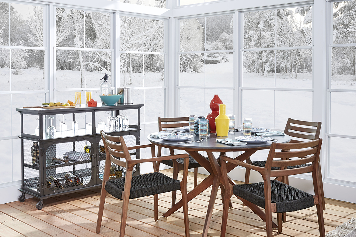 Four season room being as a dining area to enjoy the winter landscape